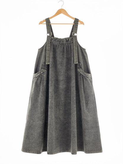 Slate Wash denim pinafore dress on a hanger, washed A-line maxi