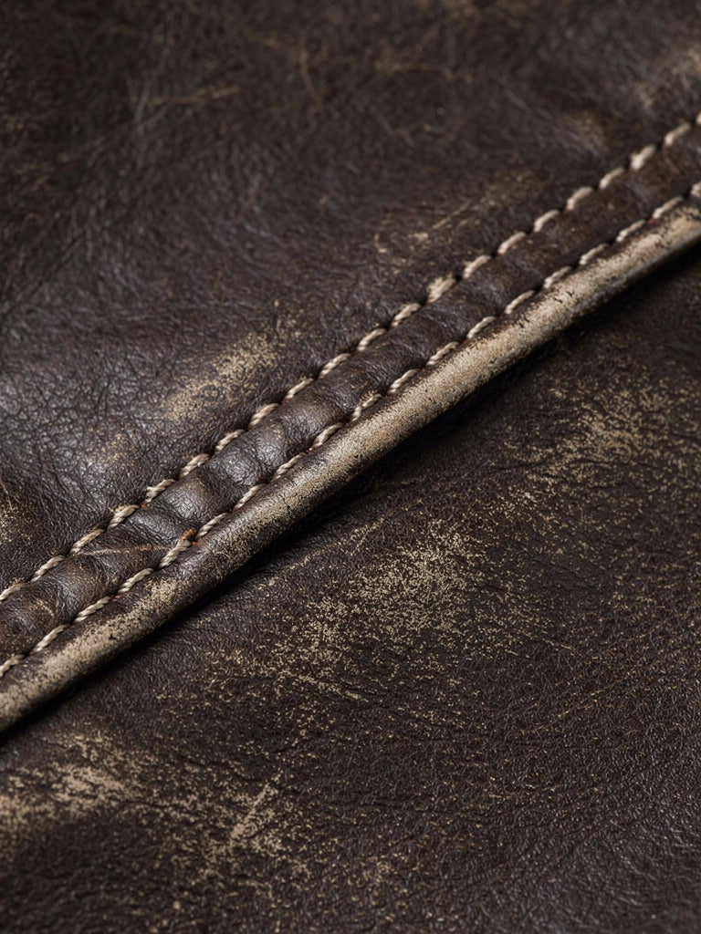 Close up of the distressed faux leather grain and the pale contrast topstitching of the Taynton bomber jacket