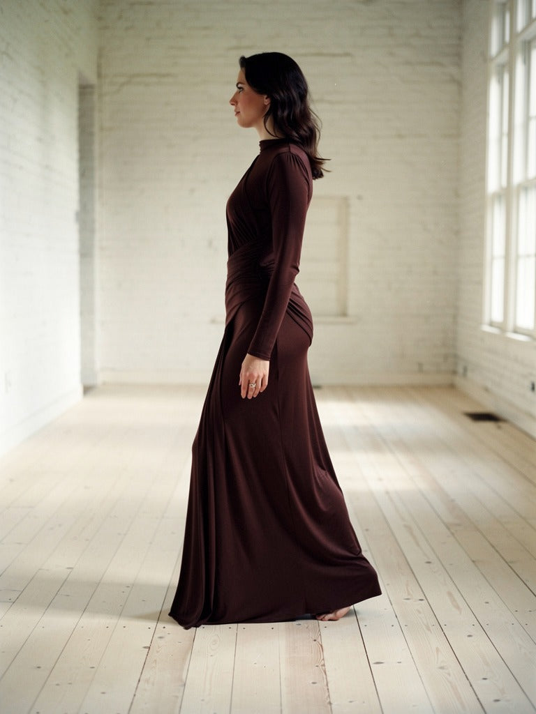 Draped maxi dress in Bourbon worn walking, side profile, hem sweeping the floor