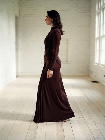 Draped maxi dress in Bourbon worn walking, side profile, hem sweeping the floor