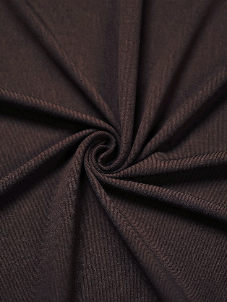 Close-up of the fine matte stretch jersey of the draped maxi dress, gathered into soft folds