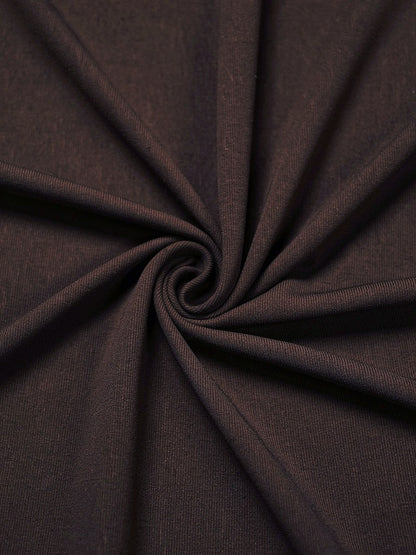 Close-up of the fine matte stretch jersey of the draped maxi dress, gathered into soft folds