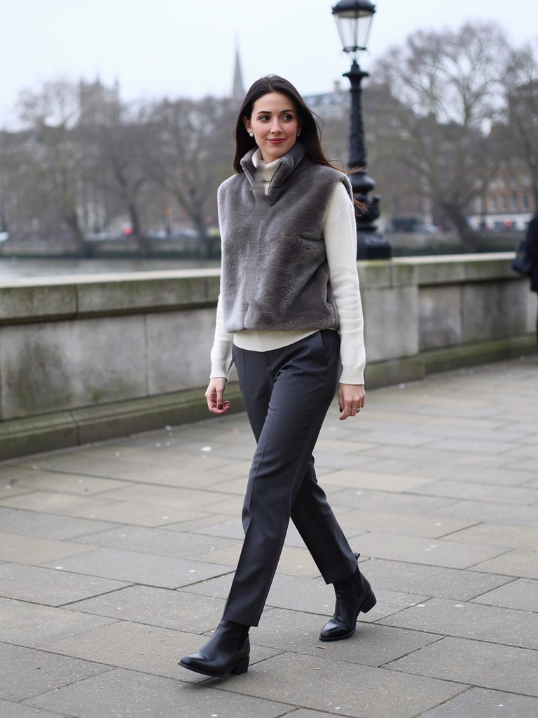Womens faux fur gilet in Ash Grey, cropped funnel neck, worn on a London river embankment