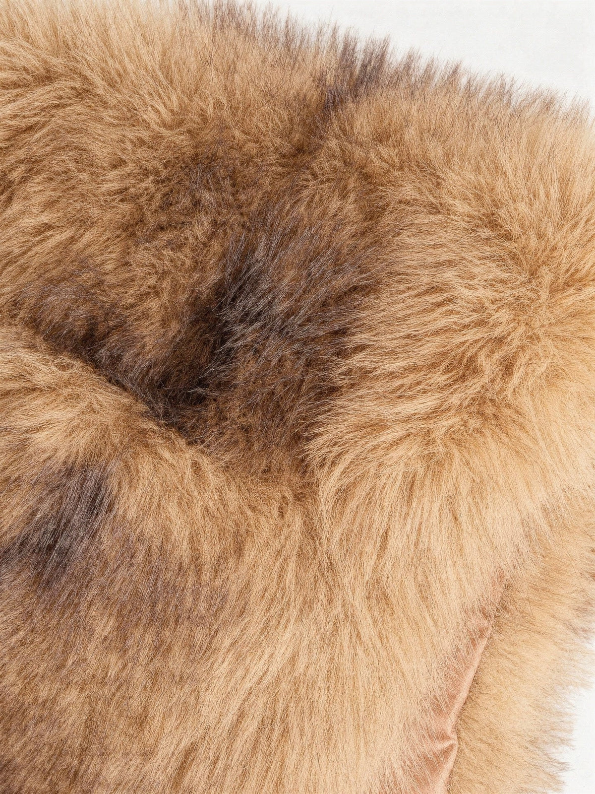 Close-up of the long banded faux fur pile, honey camel with a deep chocolate ridge