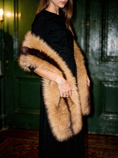Chestnut Stripe faux fur scarf worn open over a black evening dress, hanging full length at the front
