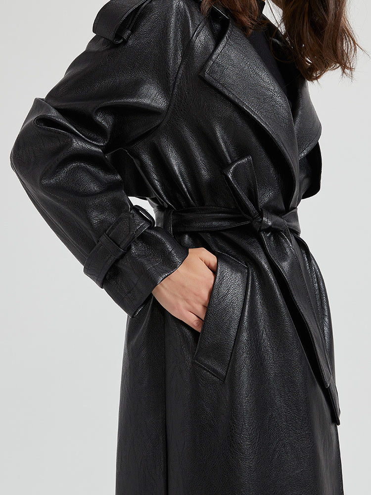 Detail of the knotted tie belt, welt pocket and buckled cuff strap