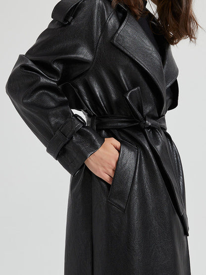 Detail of the knotted tie belt, welt pocket and buckled cuff strap