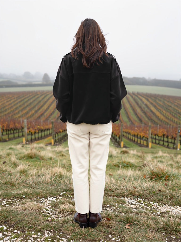 Back view of the black faux suede bomber jacket showing the batwing silhouette