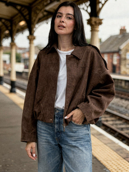 Womens cropped faux-suede jacket in chocolate brown worn on a heritage railway platform