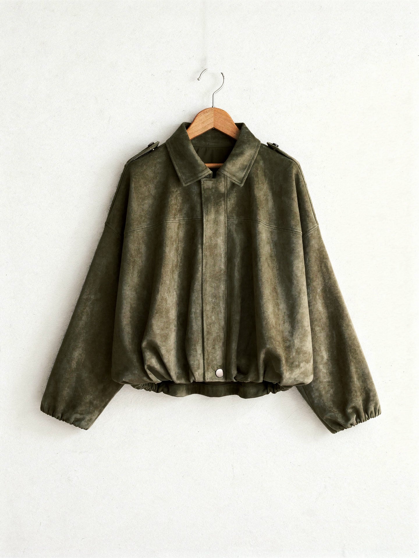 Khaki cropped faux-suede jacket with batwing sleeves on a wooden hanger
