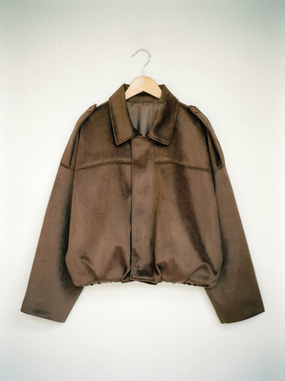 Walnut cropped faux-suede jacket with batwing sleeves on a wooden hanger