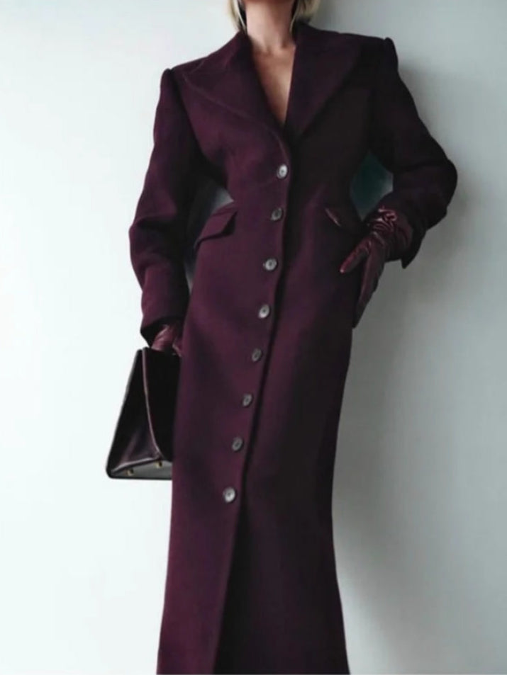 Front of the Cabernet burgundy longline coat worn with a hand in the hip flap pocket