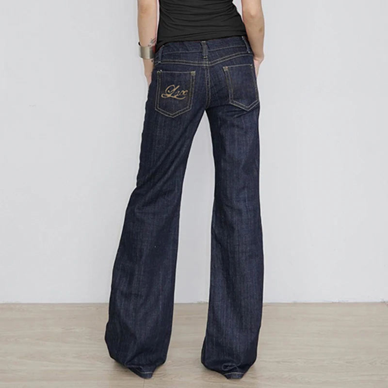 Back view of the dark indigo flared jeans showing the embroidered pocket and wide flare