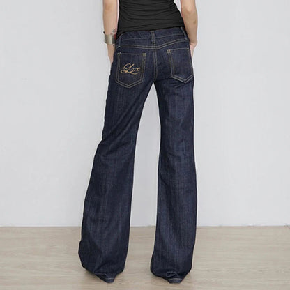 Back view of the dark indigo flared jeans showing the embroidered pocket and wide flare