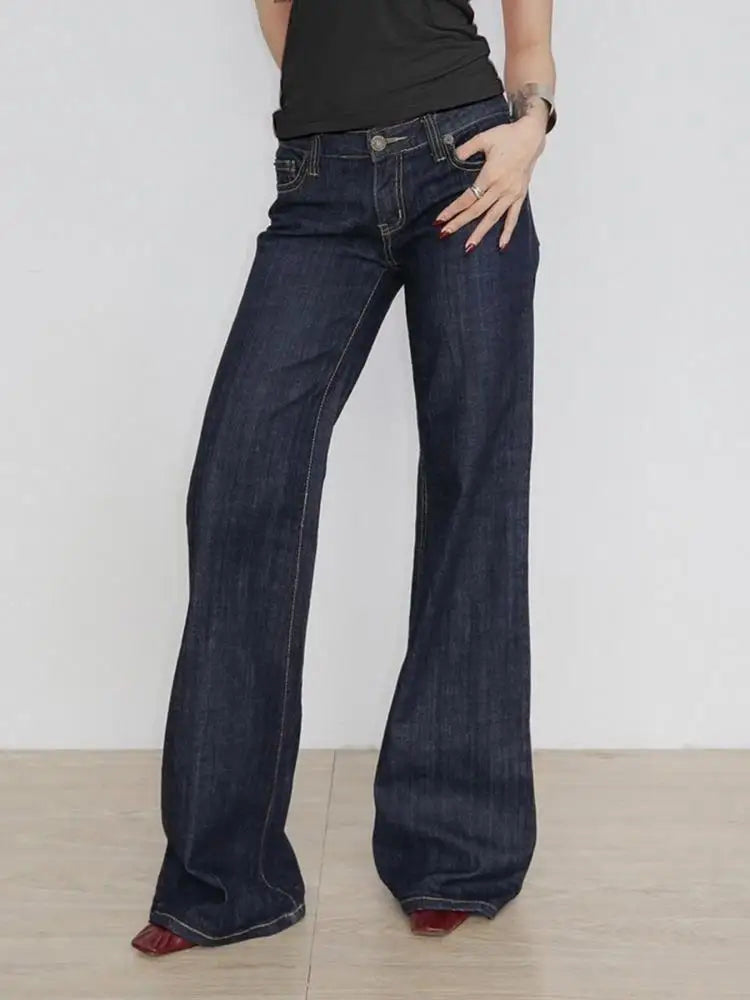Front view of the low-rise flared jeans in dark indigo worn full length