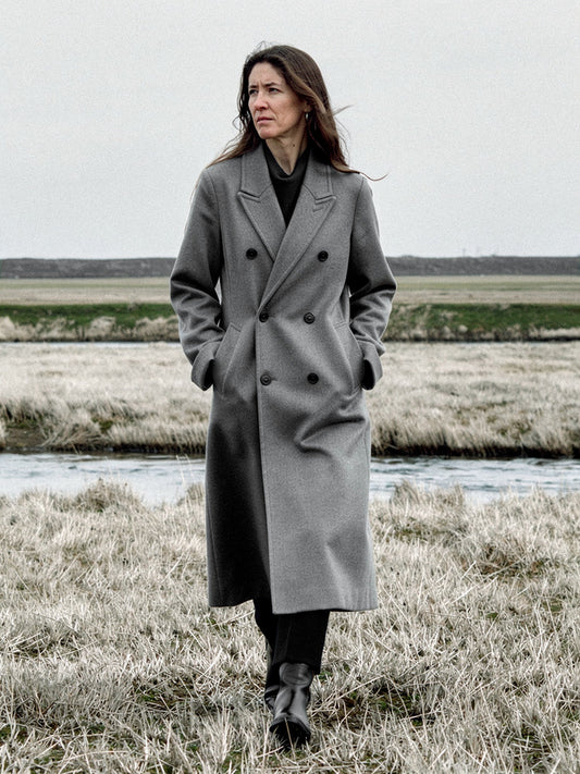 Grey wool coat worn open on a salt marsh, double breasted and oversized, falling to mid calf