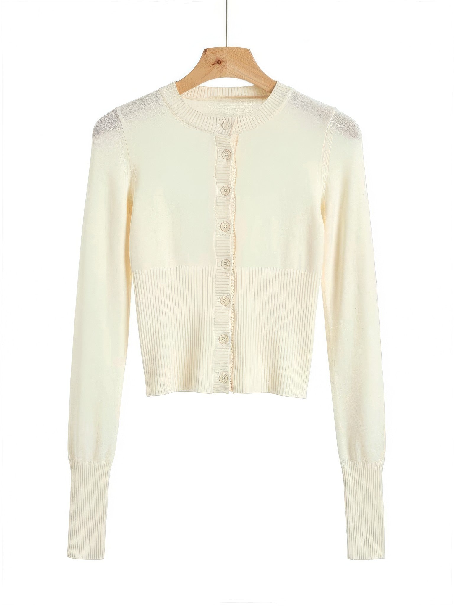 Buttermilk cropped cardigan with a scalloped rib button placket on a wooden hanger