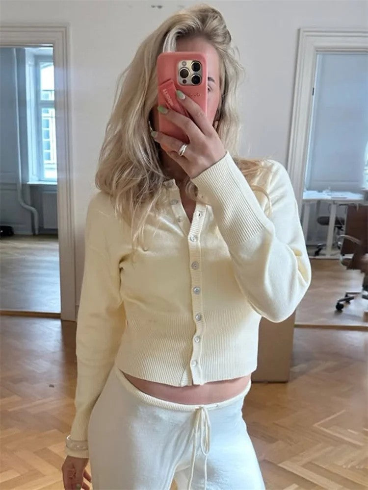 Buttermilk cropped cardigan worn with matching cream trousers