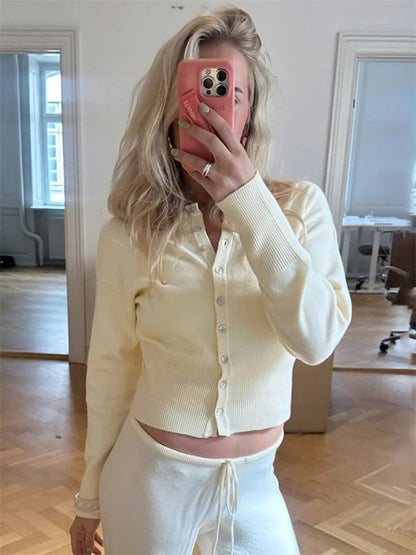 Buttermilk cropped cardigan worn with matching cream trousers