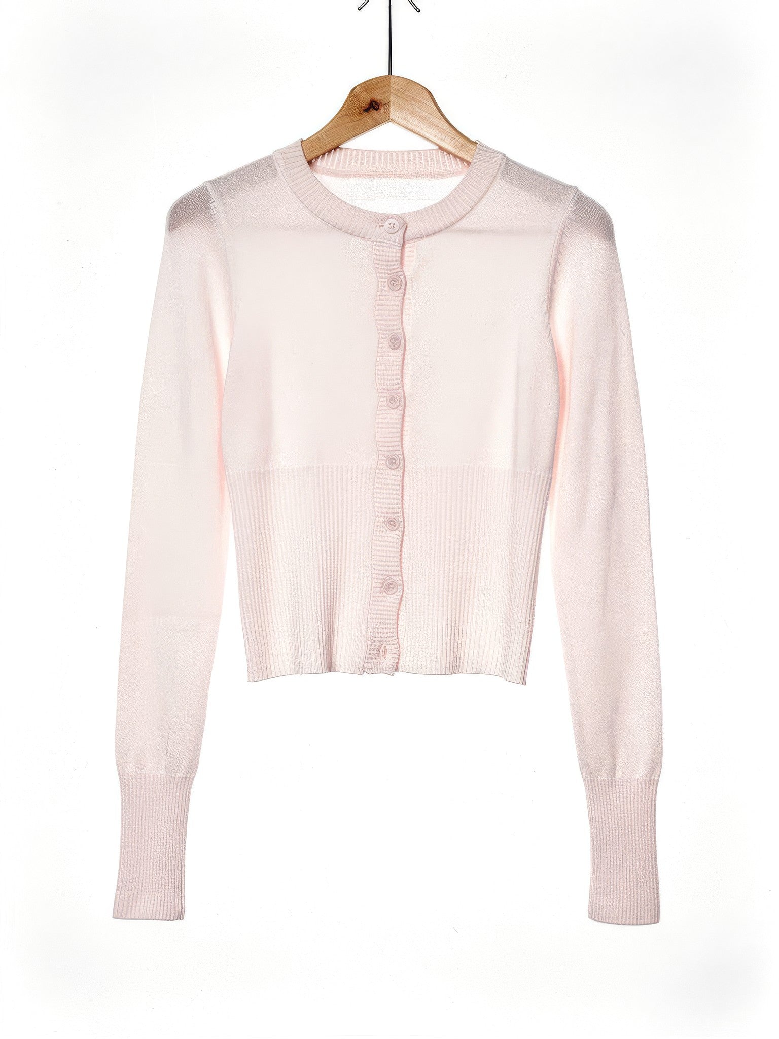 Powder pink cropped ribbed cardigan on a wooden hanger