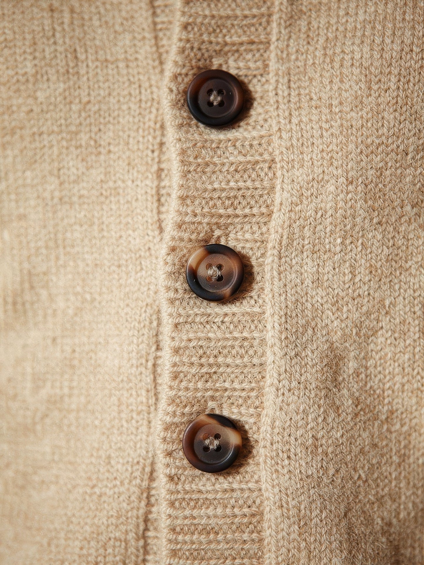 Close-up of the fine wool knit and horn buttons