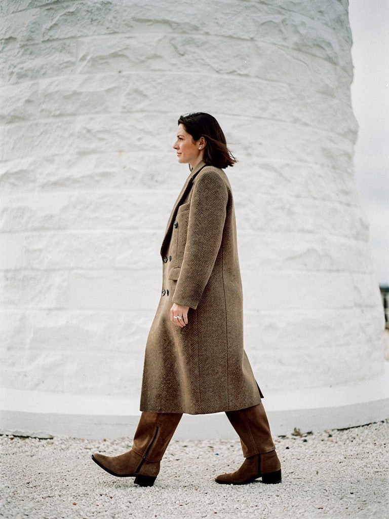 Side profile of the longline herringbone coat, hem falling to the lower calf