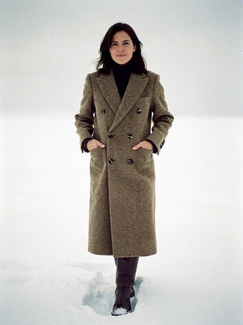 Womens herringbone coat in brindle brown tweed, double-breasted, worn across fresh snow