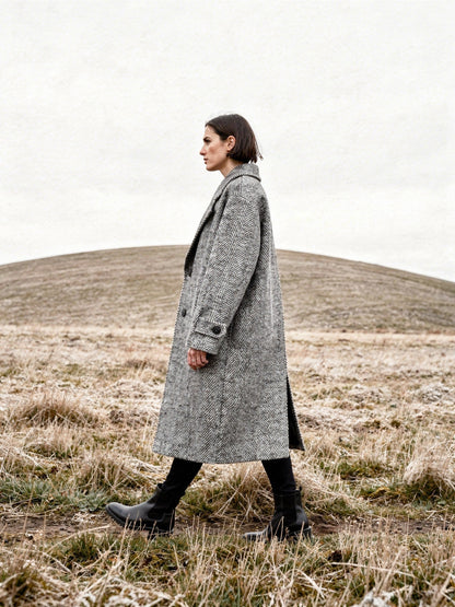 Grey herringbone midi coat worn walking on an English chalk down in winter