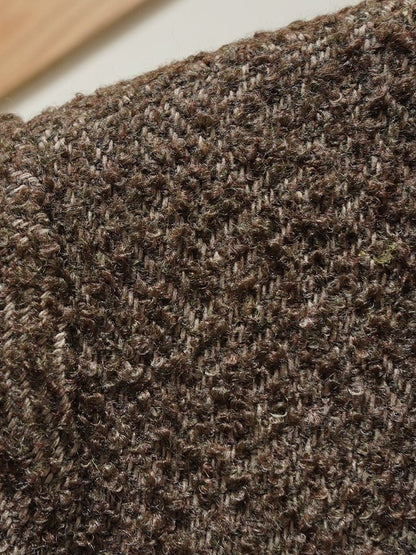 Close up of the broad brown herringbone tweed and its looped yarn