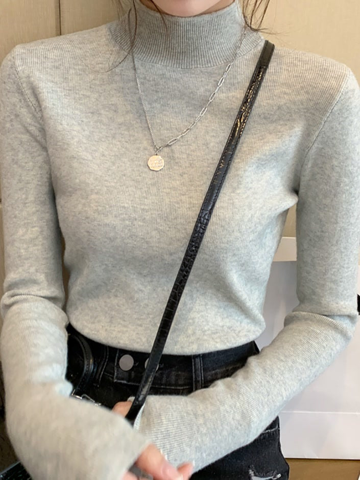 Putty high neck top in a fine rib worn tucked into jeans