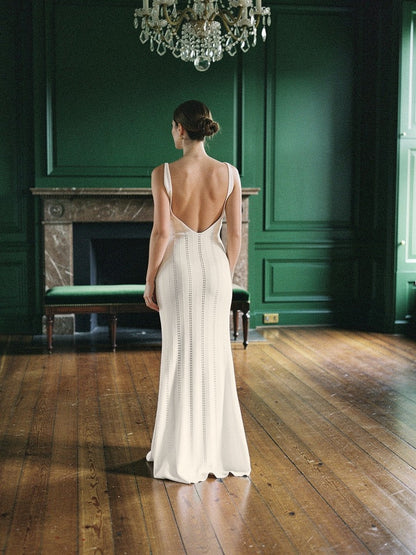 Open back knit dress in Alabaster seen from behind in a Georgian assembly room