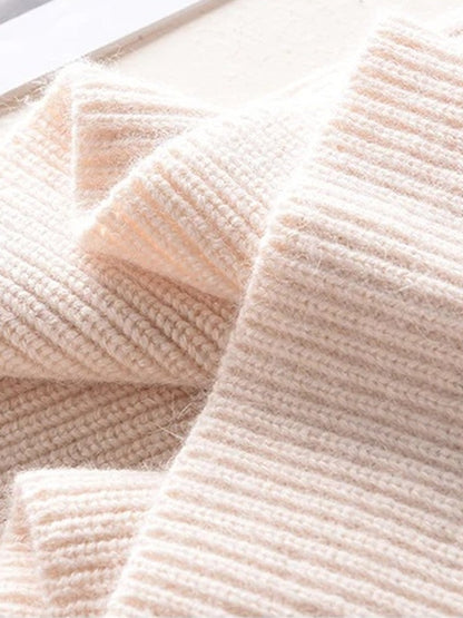 Knitted hood in Millet folded, showing the rib and the soft surface of the knit