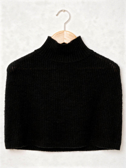 Knitted poncho in Black on a hanger, wide rib funnel neck capelet