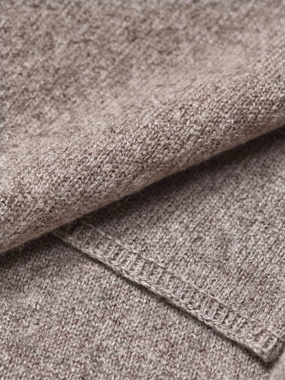 Close up of the fine knitted wool shawl fabric and its narrow linked edge