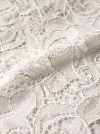 Close-up of the fine floral rose lace used on the bodice and sleeves