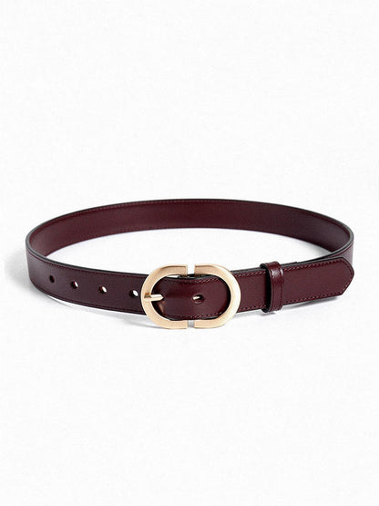 Slim leather belt in mahogany with a brushed gold oval buckle, laid flat