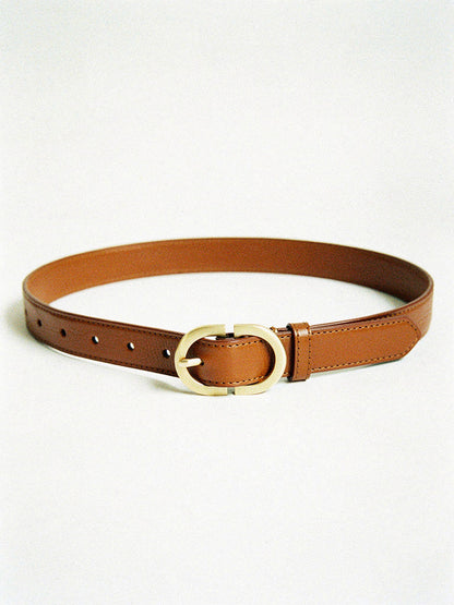 Slim leather belt in tan with a brushed gold oval buckle, laid flat