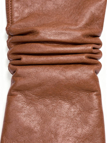 Close view of the fine sheepskin grain and gathered cuff of the leather gloves