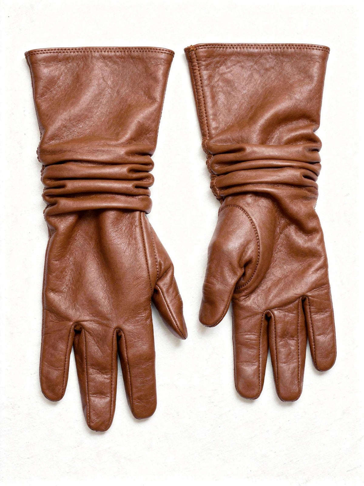 Pair of leather gloves in Kestrel tan sheepskin with long gathered cuffs, laid flat