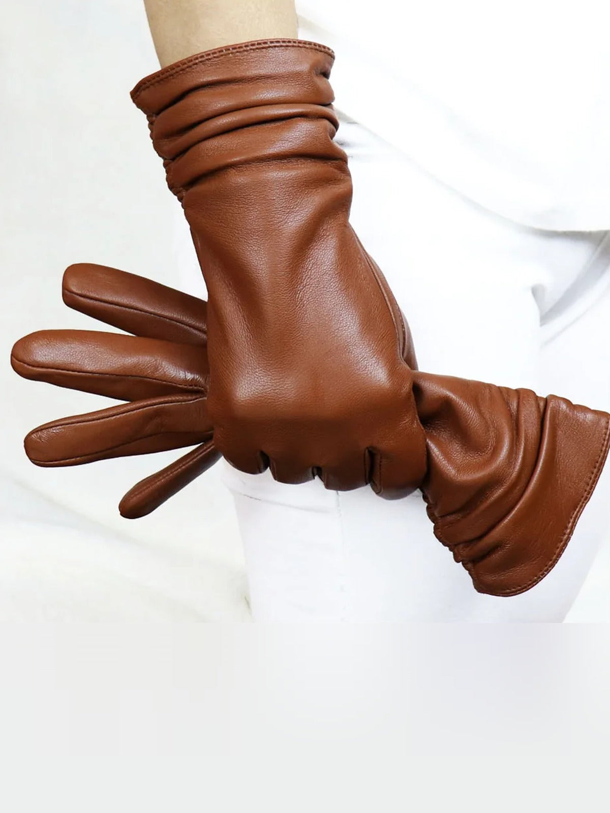 Leather gloves in Kestrel tan sheepskin, worn with the wrist gathered