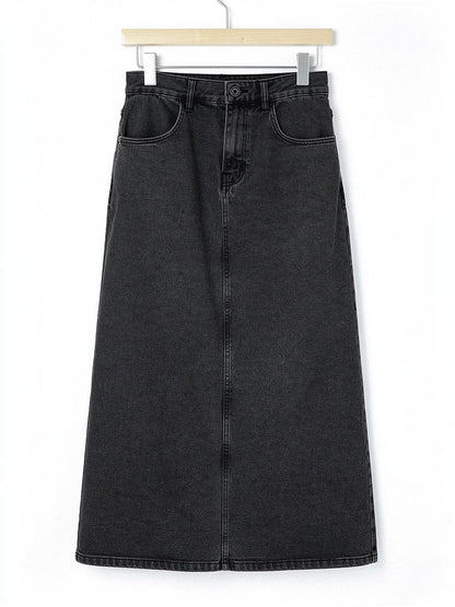 Long jean skirt in gunmetal washed charcoal denim on a plain wooden hanger against white, showing the jean waistband, the tonal topstitching and the long A-line shape