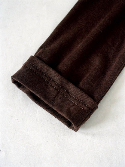 Close detail of the twin needle cuff on the espresso long sleeve top
