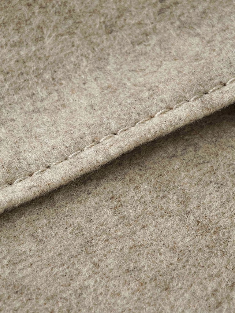 Close up of the double faced wool, showing the clean cut edge closed with a single fine stitch line and no lining