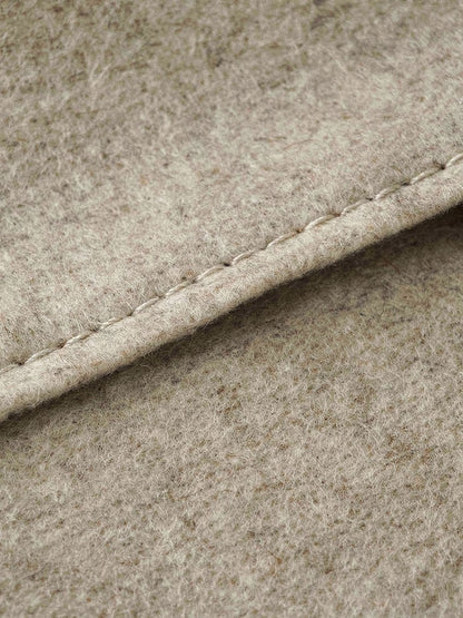 Close up of the double faced wool, showing the clean cut edge closed with a single fine stitch line and no lining