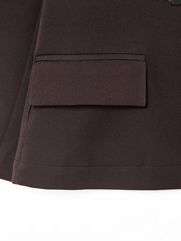 Close-up of the hip flap pocket and hem of the longline blazer