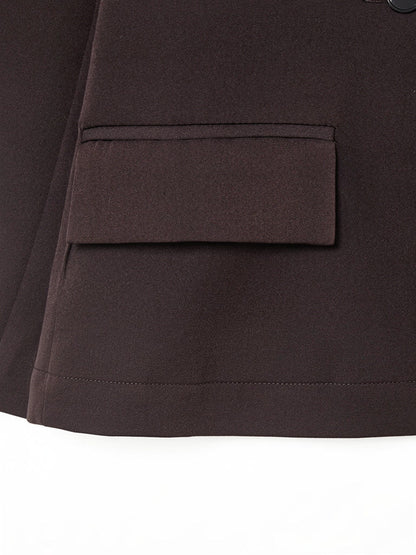 Close-up of the hip flap pocket and hem of the longline blazer