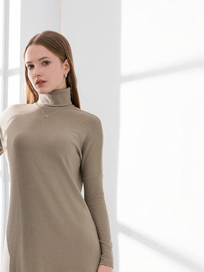 Dropped shoulder and folded roll neck of the Hessian maxi jumper dress, worn