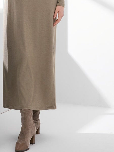 Ankle length hem and straight column of the Hessian maxi jumper dress, worn