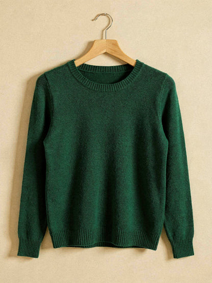 Bottle green merino wool crew neck jumper on a wooden hanger