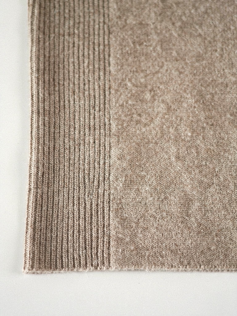 Close-up of the fine-gauge brushed merino knit and ribbed cuff of the Harlbury V-neck jumper